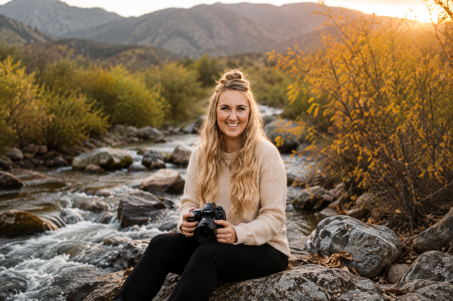 Cheyanna sitting by a creek holding her camera